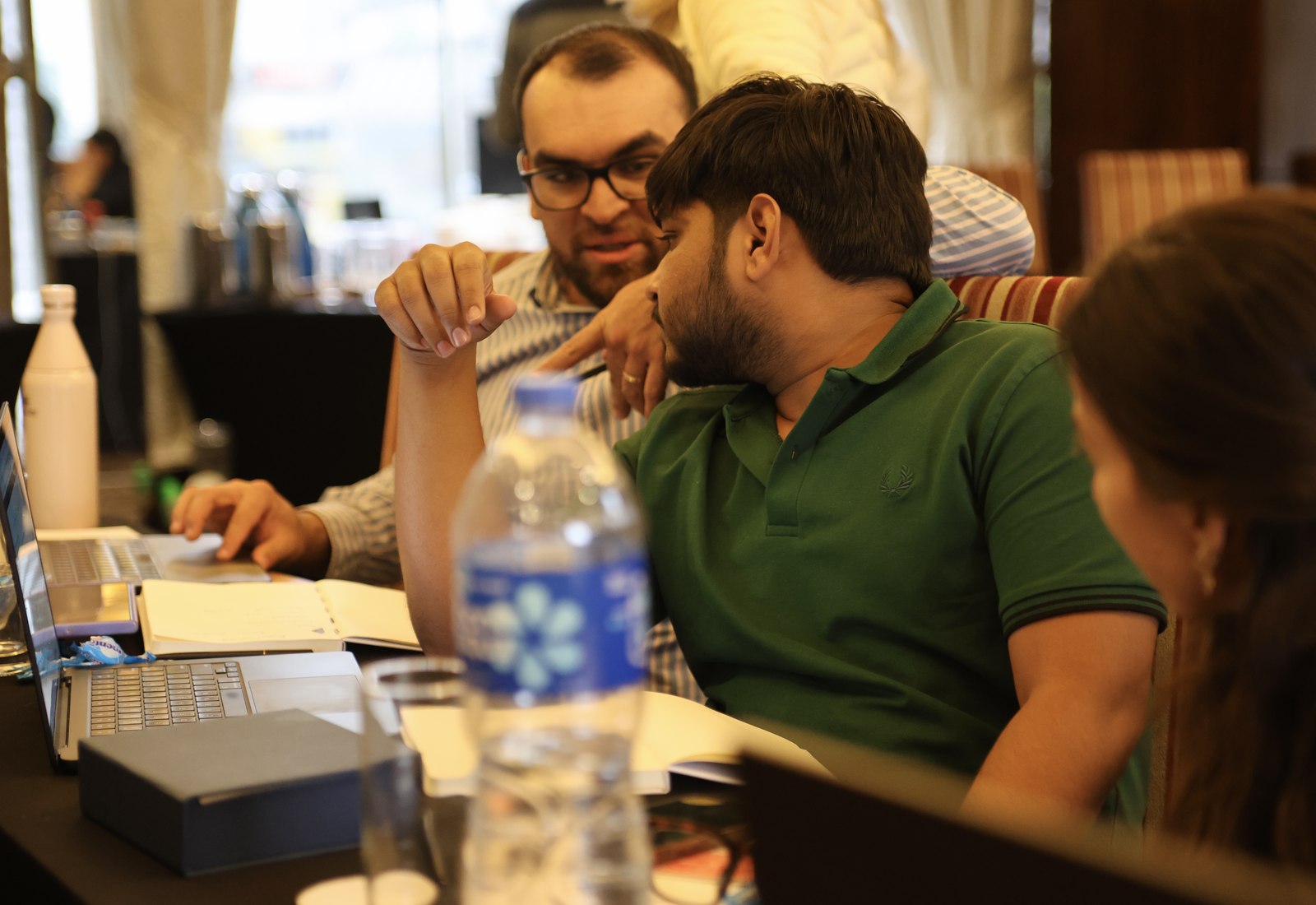 Rutvik Tolbande discussing sales strategy with a colleague